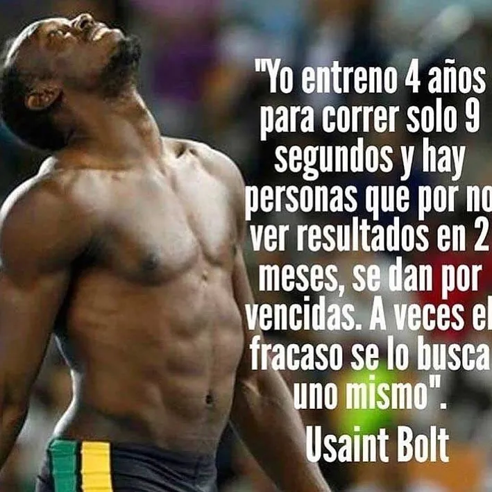 Se ve a Usain Bolt, un atleta jamaicano, en una pose de celebración tras ganar una carrera. Bolt está sin camiseta, con el torso desnudo, y lleva unos pantalones cortos negros. Tiene el pelo corto y negro, y está mirando hacia arriba con la boca abierta. Se ve muy feliz y emocionado. Está en un estadio, y hay mucha gente en las gradas.